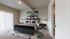 Elegant bedroom featuring a plush bed, modern decor, and ample natural light through sliding doors.