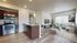 Inviting open-plan living area with modern kitchen, stylish lounge, and ample natural light.