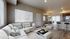 Modern open-plan living area with cozy sofa, chic dining space, and sleek kitchen featuring high-end appliances.