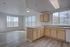 Bright and airy kitchen with modern cabinetry and large windows showcasing a scenic view, complemented by sleek flooring.
