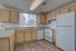 Bright and modern kitchen with elegant cabinetry, spacious countertops, and large window with scenic views.