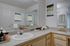 Chic and modern bathroom featuring sleek countertops, a stylish sink, and elegant wall art, providing a serene and inviting atmosphere.