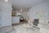 Chic and inviting living room with cozy white sofa, modern decor, and an open layout leading to a dining area. Ideal for comfortable city living.