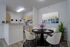 Inviting dining area with elegant decor, modern kitchen, and vibrant artwork, ideal for stylish living.