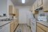 Charming kitchen with modern appliances, ample counter space, and stylish wooden cabinetry.
