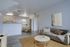 Inviting apartment living room with cozy gray sofa, modern decor, and open kitchen, perfect for relaxation and entertaining.