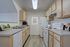 Charming kitchen with modern appliances, sleek countertops, and ample cabinet space for an organized and inviting cooking experience.
