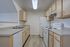 Bright and modern kitchen with light wood cabinets, sleek countertops, and stainless steel sink, perfect for culinary adventures.