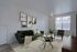 Modern living room with a stylish green sofa, chic decor, and large windows inviting natural light.