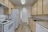 Bright and inviting kitchen with modern appliances, sleek countertops, and ample cabinetry in a contemporary apartment.