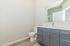 Bright and modern bathroom with sleek cabinetry, elegant fixtures, and a spacious mirror.