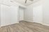 Bright and inviting room with elegant wood flooring, neutral walls, and modern white doors, perfect for a chic and cozy living space.