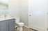 Sleek, modern bathroom featuring a contemporary vanity with a large mirror and elegant fixtures, complemented by a fresh white design.