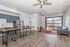 Contemporary open-concept living area with sleek kitchen, stylish breakfast bar, and expansive window view.