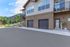 Charming two-story apartment with dual garages, set amidst scenic greenery and inviting outdoor spaces.