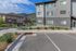 Inviting apartment building with stunning mountain views, modern exterior, and landscaped surroundings.