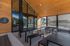 Chic outdoor lounge area with modern wooden design and stylish seating at The Eddy in Grand Junction, creating a perfect social space.