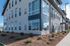 Modern apartment exterior showcasing large windows, sleek design, and well-maintained landscaping.