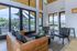 Bright and modern lounge area with leather seating, large windows, and scenic outdoor views, perfect for relaxation and entertaining.