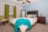 Inviting bedroom featuring a plush bed with vibrant teal accents, elegant furnishings, and a serene ambiance.