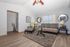 Chic living room showcasing modern decor with a cozy rug, elegant seating, and stylish wall mirrors creating a welcoming ambiance.