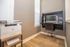 Bright home office nook featuring a sleek wall-mounted desk, modern computer setup, and efficient HP printer, ideal for productivity.