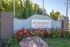 Charming entrance sign for Aberdeen at 2300 Wakarusa Drive, framed by vibrant flowers and lush greenery, offering a welcoming first impression.