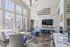 Bright and inviting communal living space featuring modern seating, large windows, and a stylish wall-mounted TV, ideal for relaxation and entertainment.