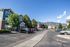 Charming apartment complex with scenic mountain views, ample parking, and lush green surroundings.
