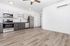 Modern kitchen featuring sleek cabinetry, stainless steel appliances, and open space design with beautiful wood flooring.