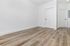 Sleek modern room featuring elegant wood flooring and crisp white walls, perfect for a fresh, minimalist design.