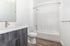 Modern bathroom with sleek cabinetry, elegant fixtures, and a spacious bathtub offering a clean, contemporary look.
