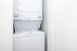 Compact laundry area with a sleek, modern stacked washer and dryer, perfect for efficient apartment living.