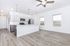 Bright and modern open-concept kitchen with sleek white cabinetry, stainless steel appliances, and elegant pendant lighting.