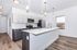 Bright and modern kitchen with sleek cabinetry, stainless steel appliances, and a spacious island with pendant lighting.