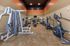 Modern fitness center with state-of-the-art exercise equipment, featuring treadmills, elliptical machines, and a multi-station gym setup.
