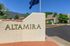 Elegant entrance of Altamira Apartments with mountain views and lush greenery.