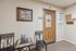 Welcoming leasing office with elegant decor, cozy seating, and inviting wooden door.
