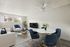 Chic living space with elegant furniture, featuring a plush sofa, stylish armchairs, and a sleek dining area, ideal for relaxation and entertaining.