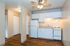 Charming kitchen with sleek white cabinets, modern appliances, and elegant hardwood floors, perfect for cozy culinary adventures.