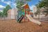 Inviting outdoor playground amidst serene apartment surroundings with vibrant slide set under the clear blue sky.