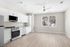 Bright, modern kitchen with sleek white cabinets, stainless steel appliances, and expansive hardwood floors.