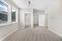 Bright bedroom with plush carpet, large windows offering scenic mountain views, and convenient direct access to a modern en-suite bathroom and spacious walk-in closet.
