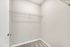 Spacious and organized walk-in closet with ample shelving, perfect for maximizing storage in a modern home.