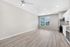 Bright open-concept kitchen and living space with elegant light wood flooring and modern stainless steel appliances.