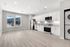 Sleek open-concept kitchen and living area with modern appliances and stunning mountain views through large windows.