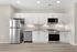 Modern kitchen with sleek stainless steel appliances, elegant white cabinetry, and under-cabinet lighting.