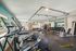 Modern fitness center featuring state-of-the-art equipment, ample natural light, and a sleek design for optimal workouts.