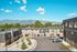 Scenic apartment complex with mountain views, modern amenities, and ample parking under a bright blue sky.