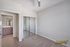 Bright and modern room with sleek hardwood floors, mirrored closet doors, and an elegant bathroom entrance at The Chateau Apartments.